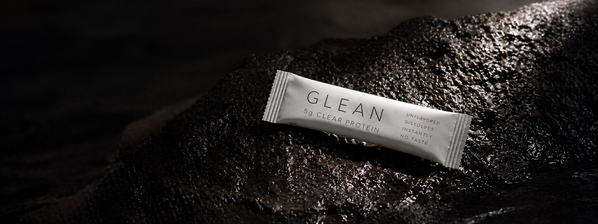 Glean stick pack on wet black stone